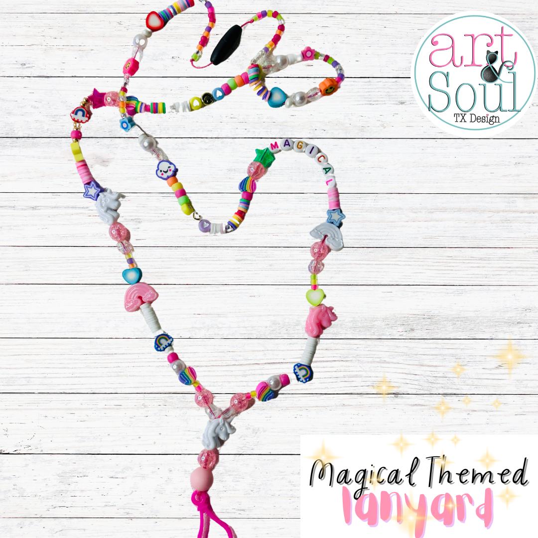 The full magical unicorn themed lanyard and a wooden table.  All the colorful beads, unicorns, stars, and rainbows can be seen with a focus on the lettered beads that spell "MAGICAL" on the right side of the lanyard,