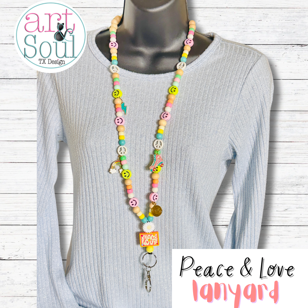 The groovy Peace and Love Lanyard on a mannequin wearing a grey sweater.