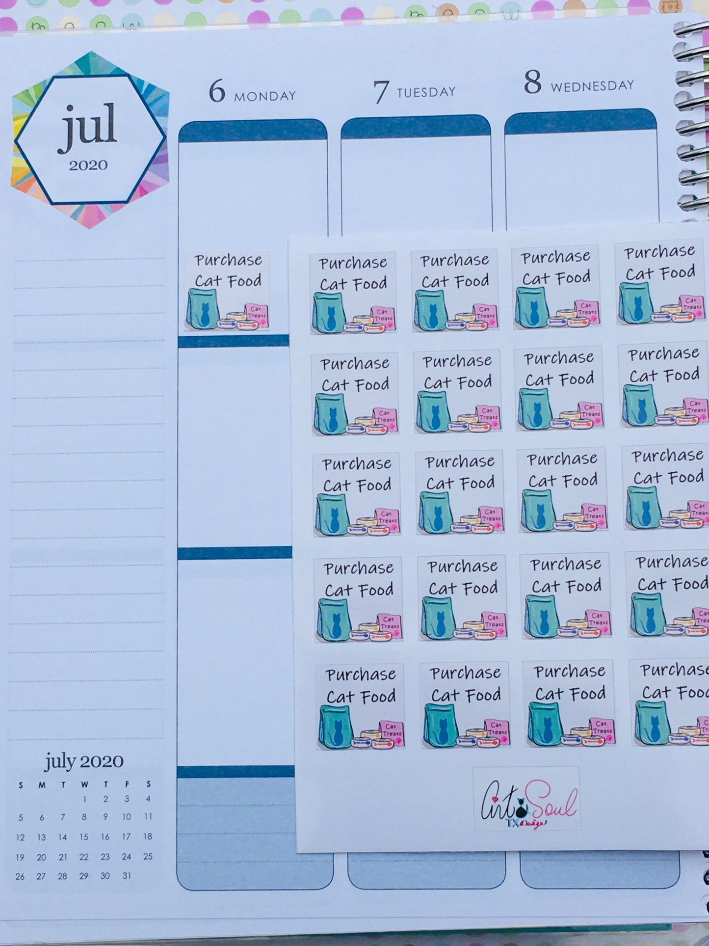 A sheet of Purchase Cat Food Pet Stickers and a single sticker inside an Erin Condren Life Planner.